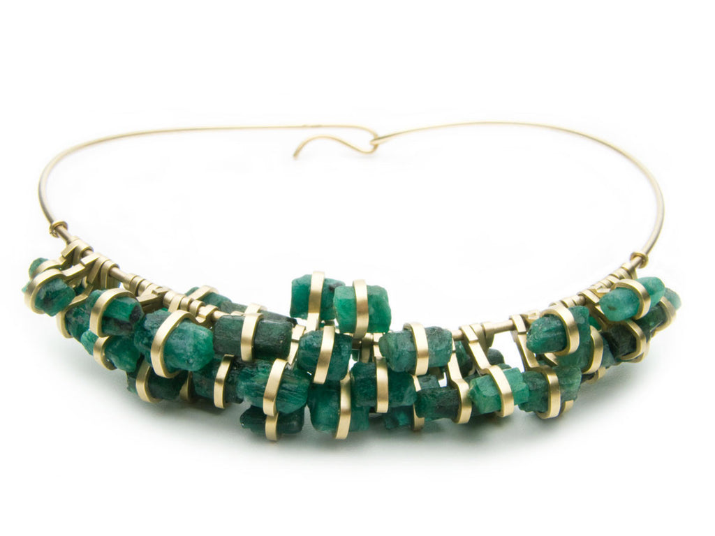 Fifty-two Emerald chunks set in eighteen karat yellow gold, suspended on a gold neck ring. Commissioned work. $0.00