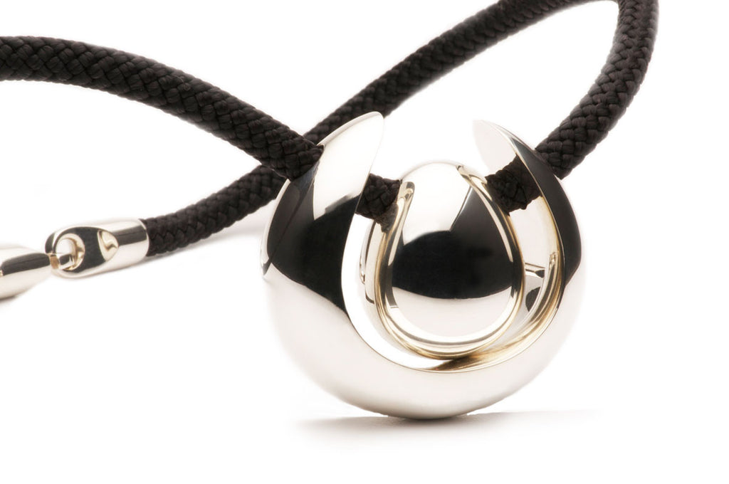 Sterling Silver pendant on a black silk cord with a tubular puzzle clasp. $1,680.00