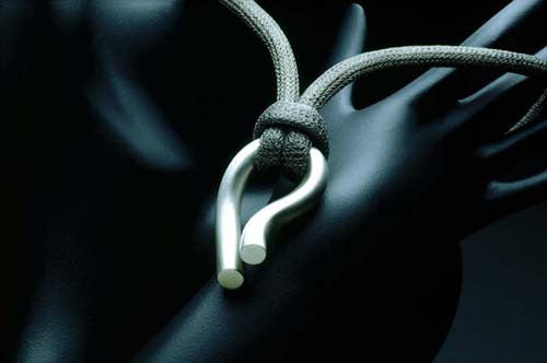Sterling silver pendant on steel mesh or silk cord, tubular puzzle clasp. Satin matte or highly polished. $990.00
